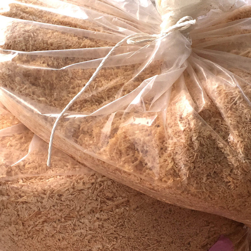 Image of hinoki chips in plastic bag to be used for  enzyme bath
