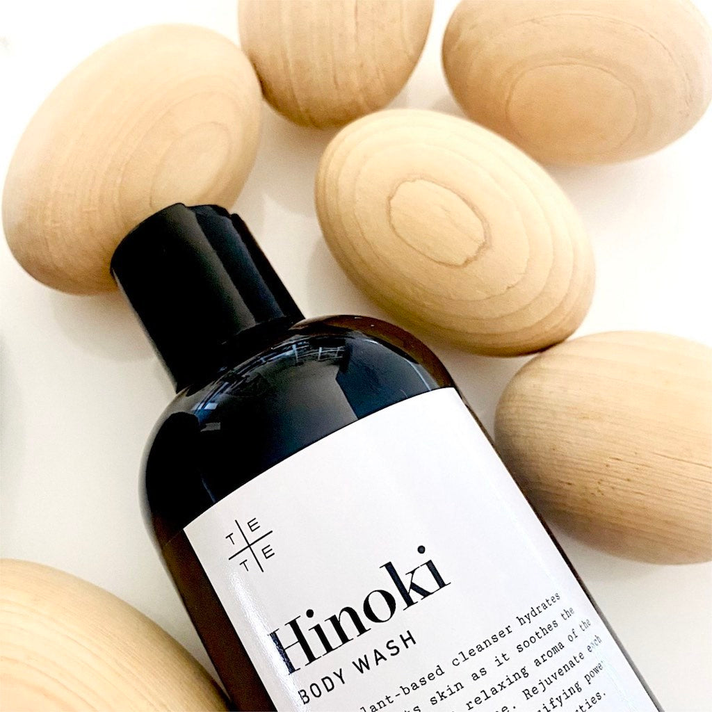 Aromatic Japanese Hinoki wood shavings surrounding botanical body wash — TE PLUS TE