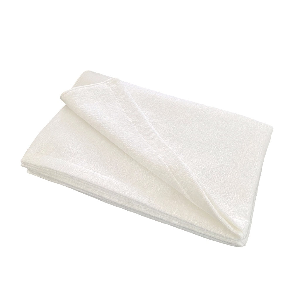 Folded Japanese natural white towel on a white background