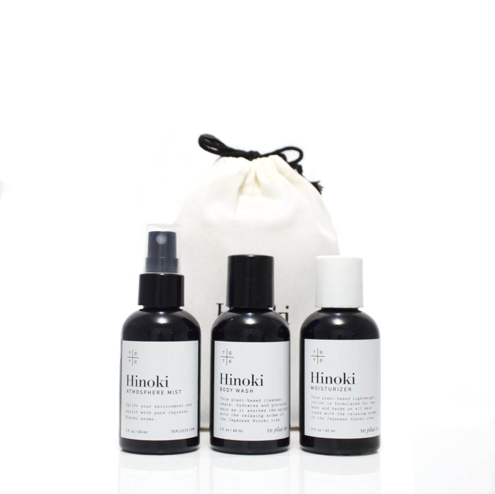 Three Hinoki skincare products with a drawstring bag on a white background