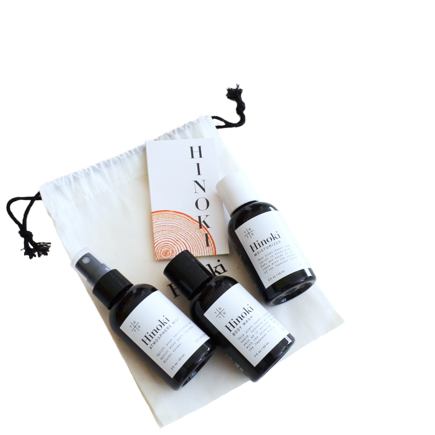 Three black bottles with white labels on a white background, featuring the brand 'Hinoki'.