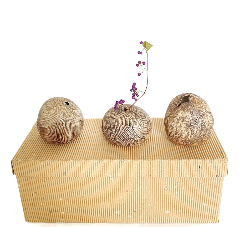 Handcrafted storage box with three decorative ceramic vases on a white background