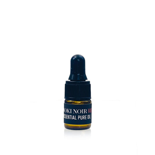 Small bottle of Rokki Noir essential pure oil on a white background