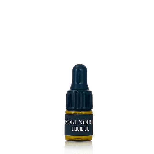 Bottle of Enoki Noir liquid oil on a white background