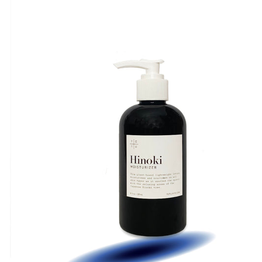 Black bottle of Hinoki moisturizer with a white label on a white background