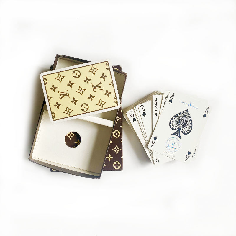 Playing cards with a Louis Vuitton design on a white background