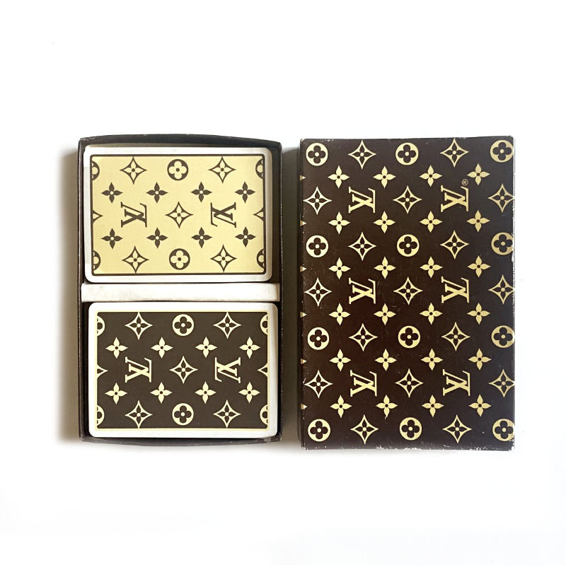 Louis Vuitton-patterned playing cards with a black and gold design.