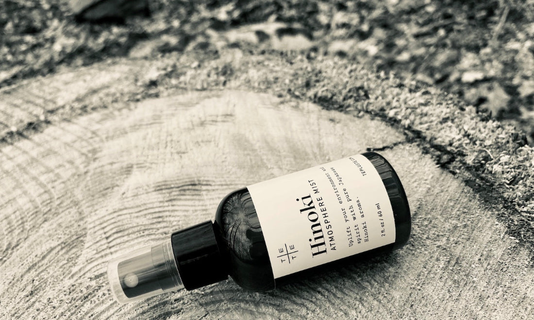 Hinoki essential oil bottle on a wooden surface