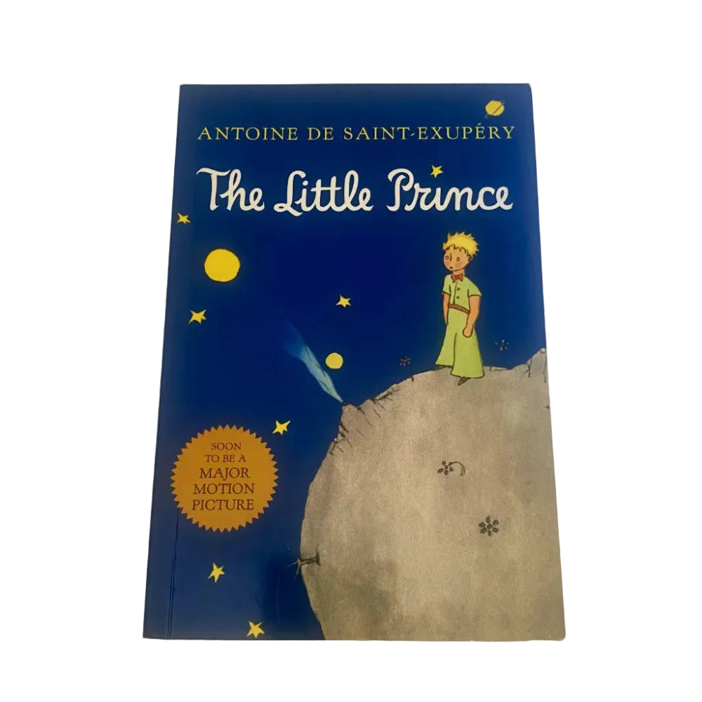 Book cover of 'The Little Prince' by Antoine de Saint-Exupéry with a child on a planet and stars in the background.