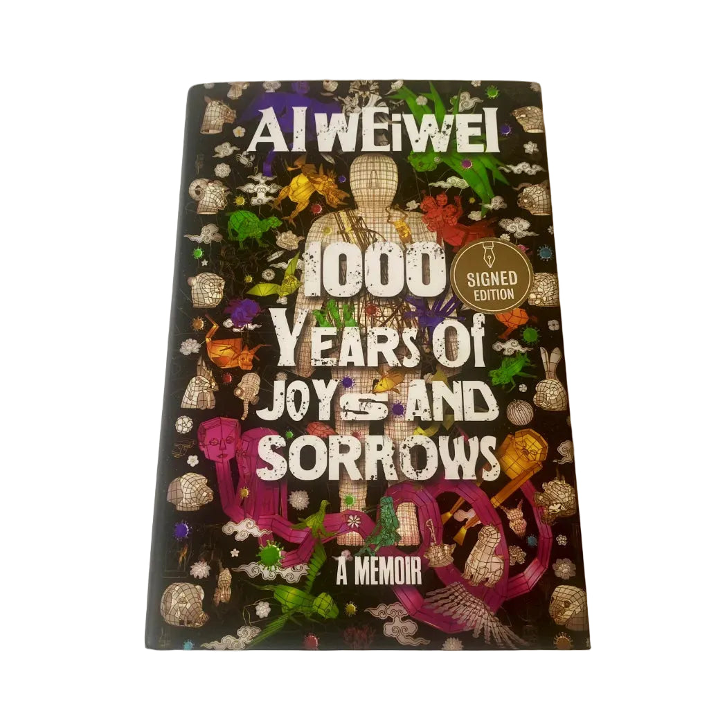 Book titled '1000 Years of Joys and Sorrows' by Ai Weiwei on a white background