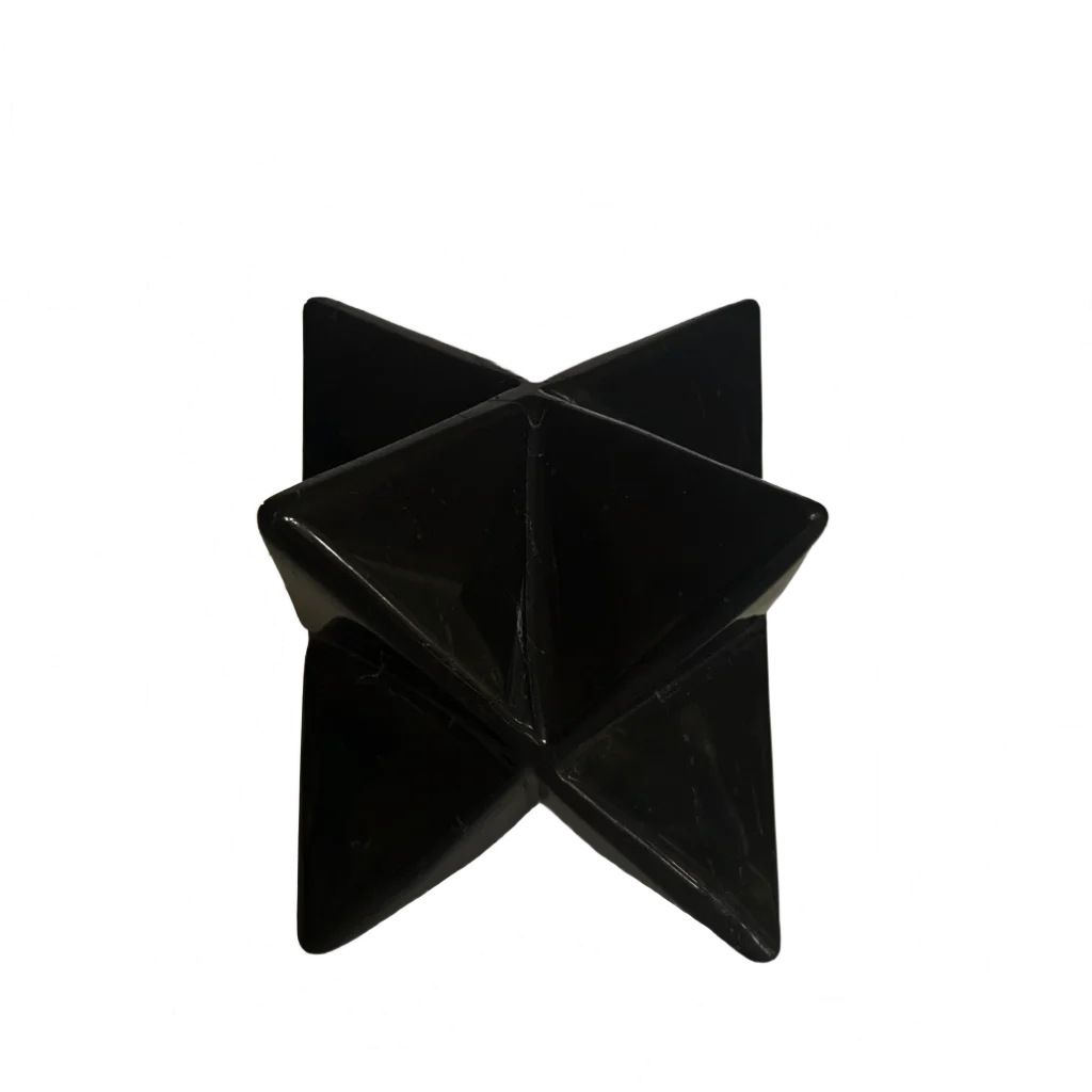 A black, Obsidian Star, faceted geometric star-shaped object made of polished stone, photographed against a solid white background.