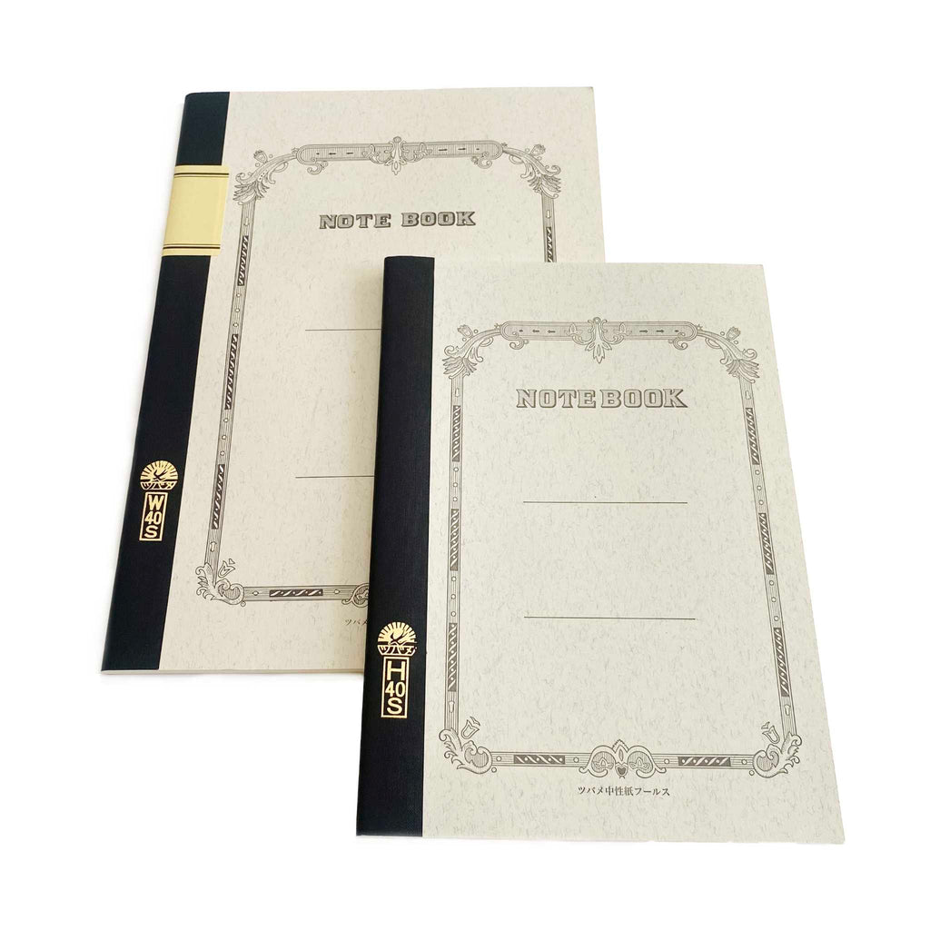 Two notebooks with black binding straps on a white background