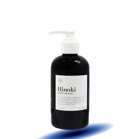 Black bottle of Hinoki moisturizer with a white label on a white background