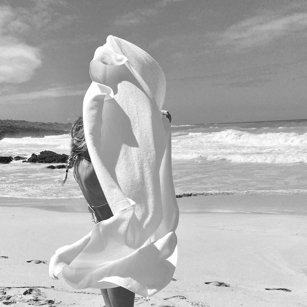tepluste-collection page Japanese towe held up by young girl on the beach. black and white photograph