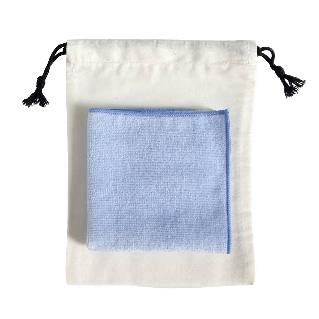Light blue Mini Towel Made in Japan folded on bag — TE PLUS TE