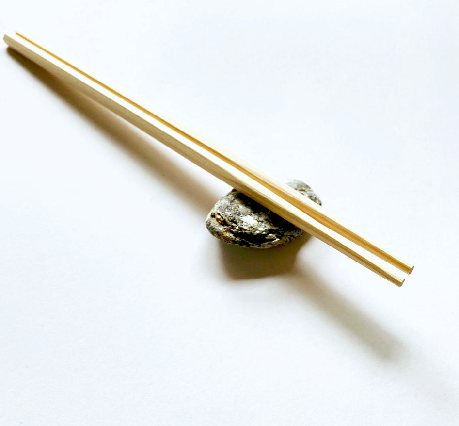 Hinoki Chopstick sit on a small rock 