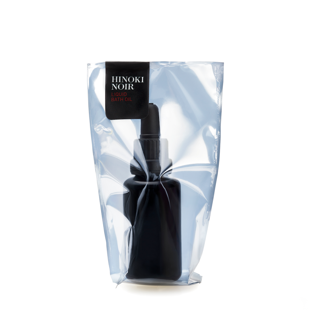 Black glass bottle with top in translucent package with black label in white background Hinoki Noir Red 